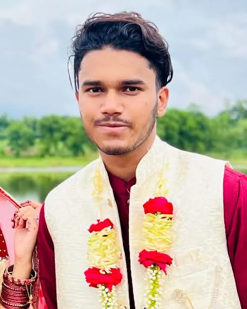 Efran in a cream koti and maroon panjabi with a rose garland